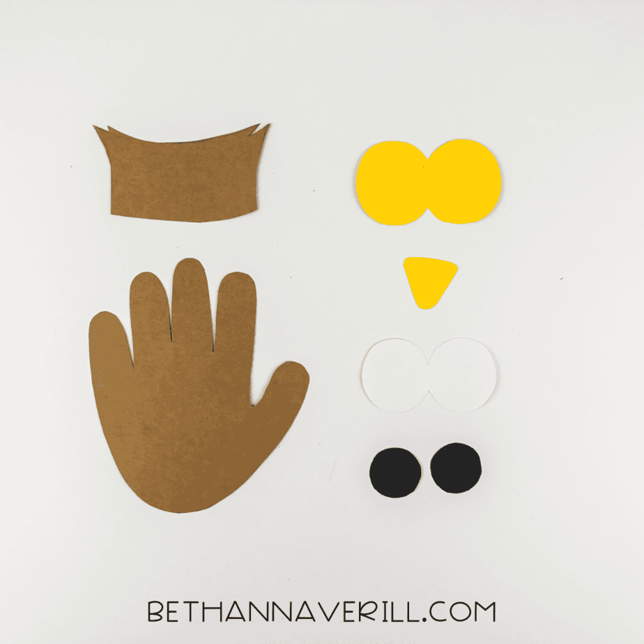 Cut-out pieces: handprint, eyes, beak, and ear tufts for owl craft