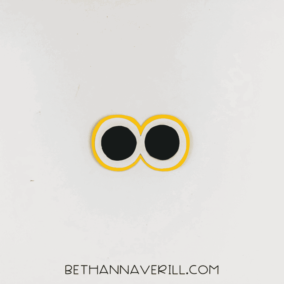 Completed layered eyes with black, white, and yellow circles