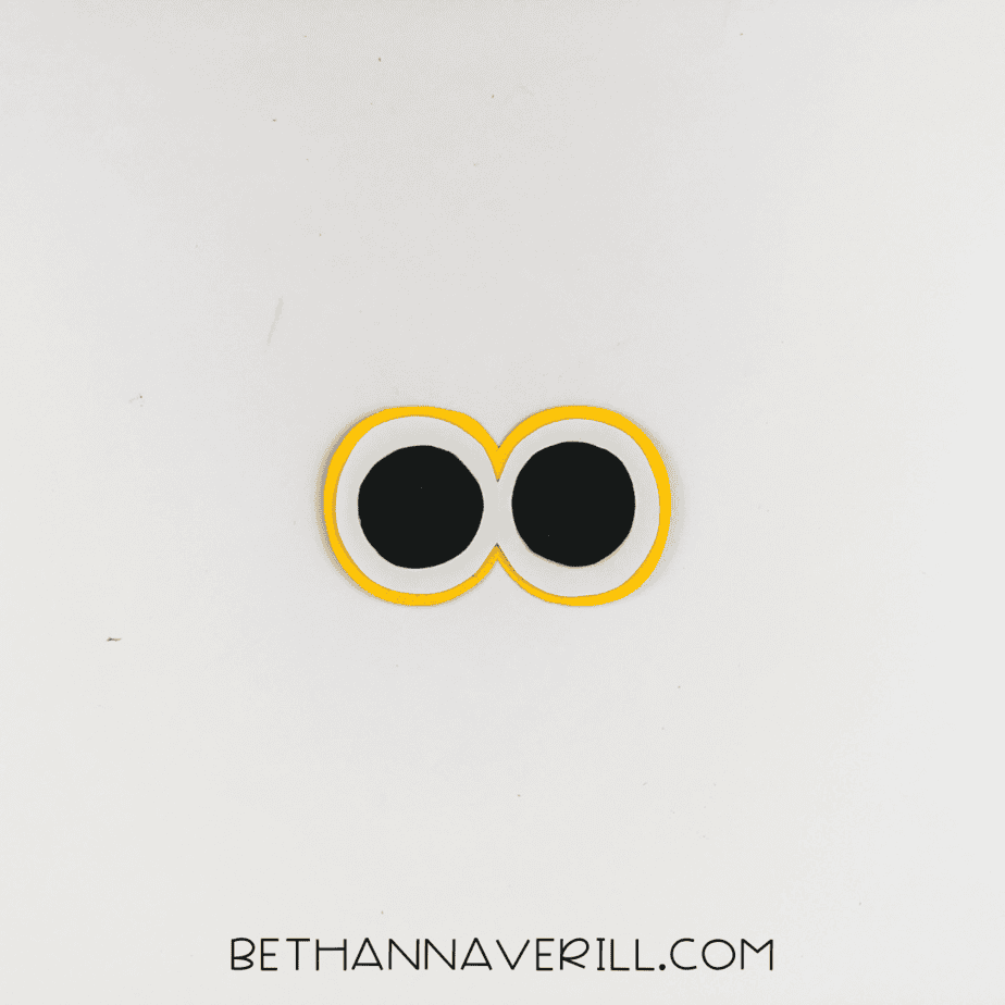 Completed layered eyes with black, white, and yellow circles