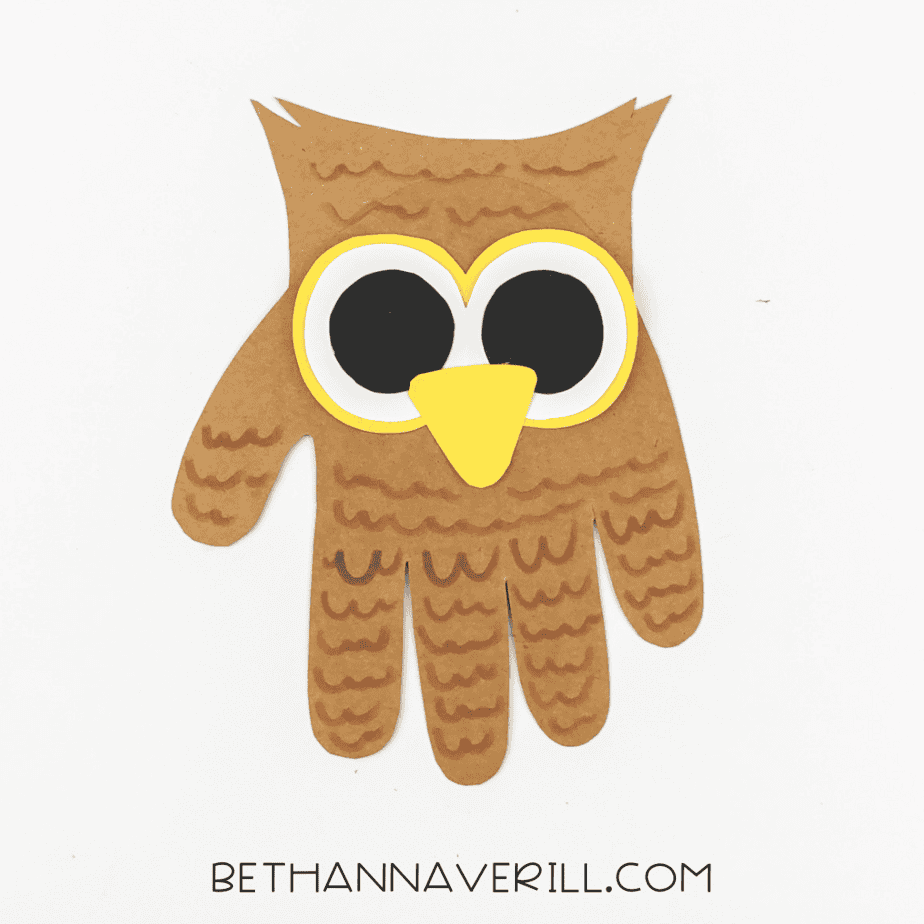 Owl handprint with feather details drawn using brown marker