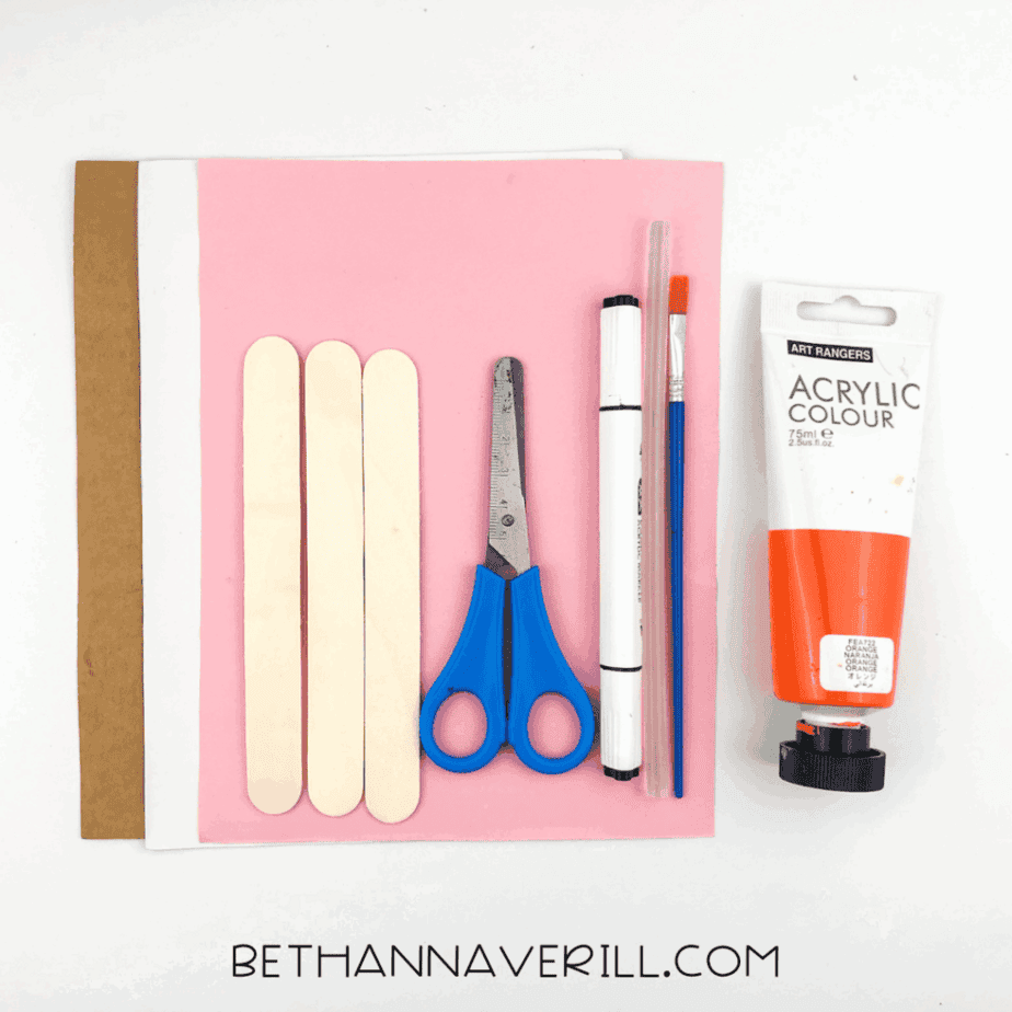 Supplies for popsicle stick pencil craft including craft sticks, paper, paint, scissors, glue, and marker.