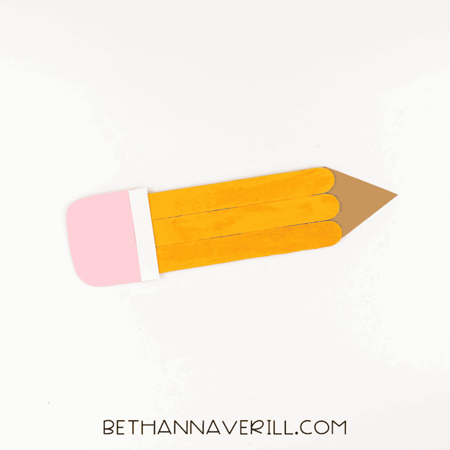 Pencil craft assembled with pink eraser, white band, orange body, and brown tip.