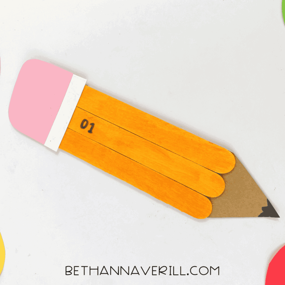 Completed popsicle stick pencil craft shown as a fun back-to-school project.