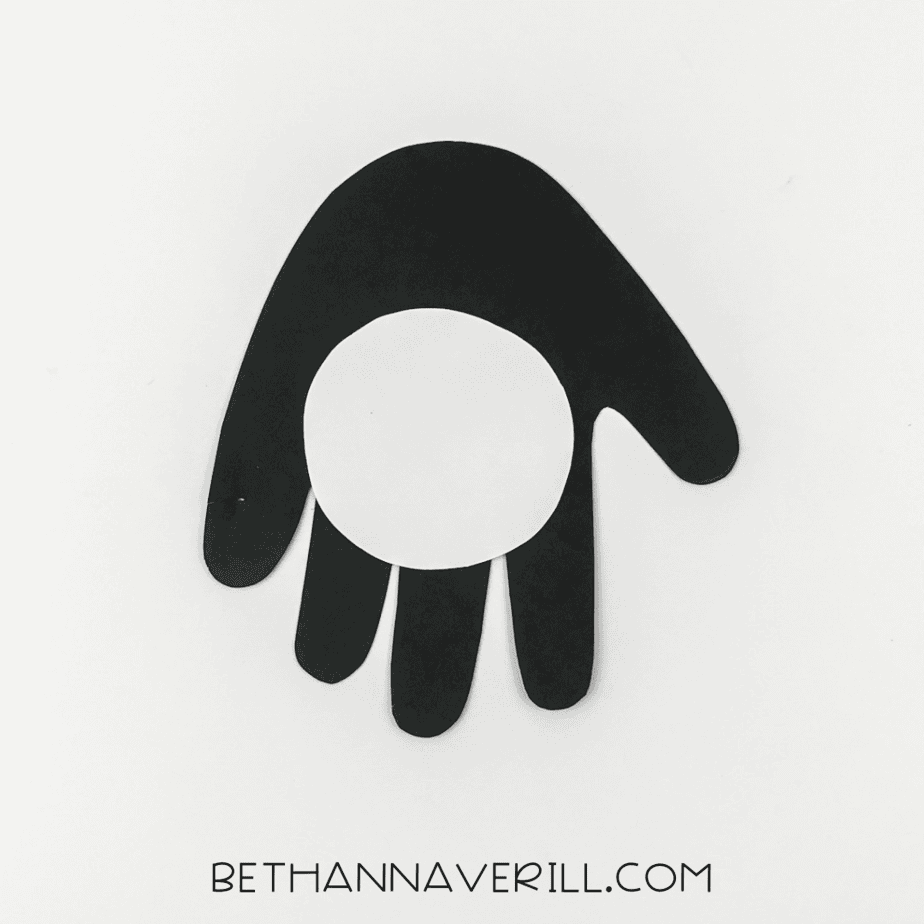 Penguin belly glued onto the black handprint