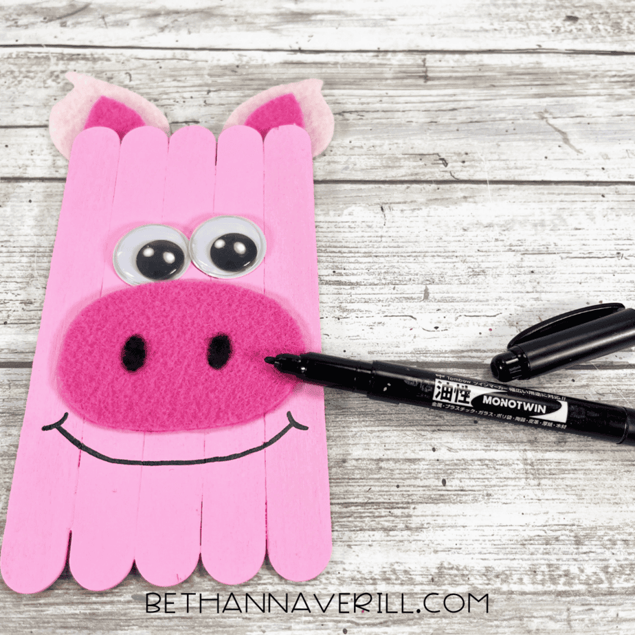 Pig craft with googly eyes and snout glued, black marker adding nostrils and smile.