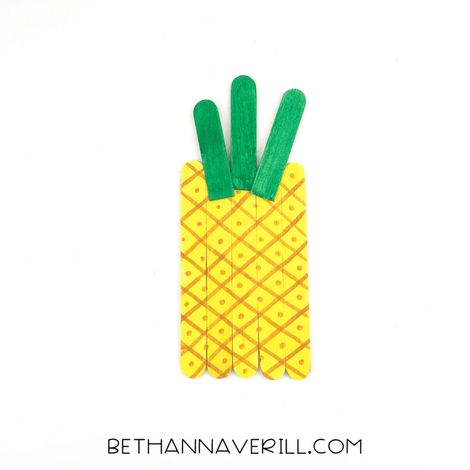 Three green sticks glued to the top of the pineapple base to form the leafy crown.