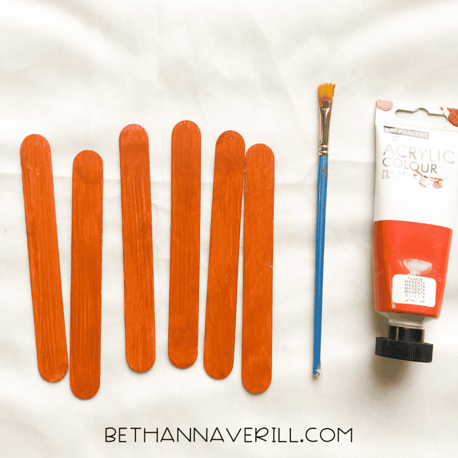 orange painted popsicle sticks