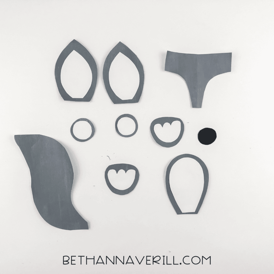 Gray outlines trimmed from the shapes to create ear frames, eye rings, belly and paw outlines.