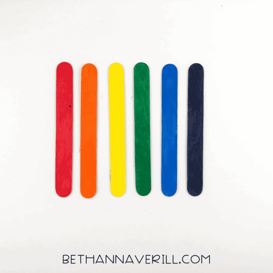 Six popsicle sticks painted in rainbow colors.