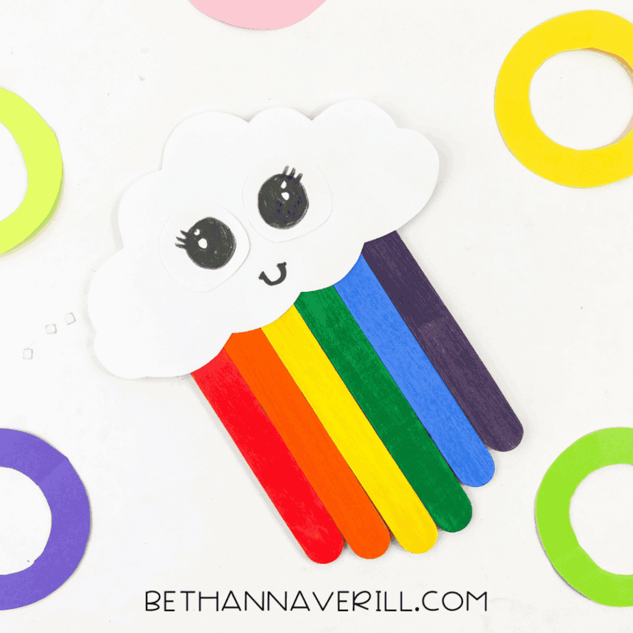 Final photo with the rainbow cloud craft on colorful background.