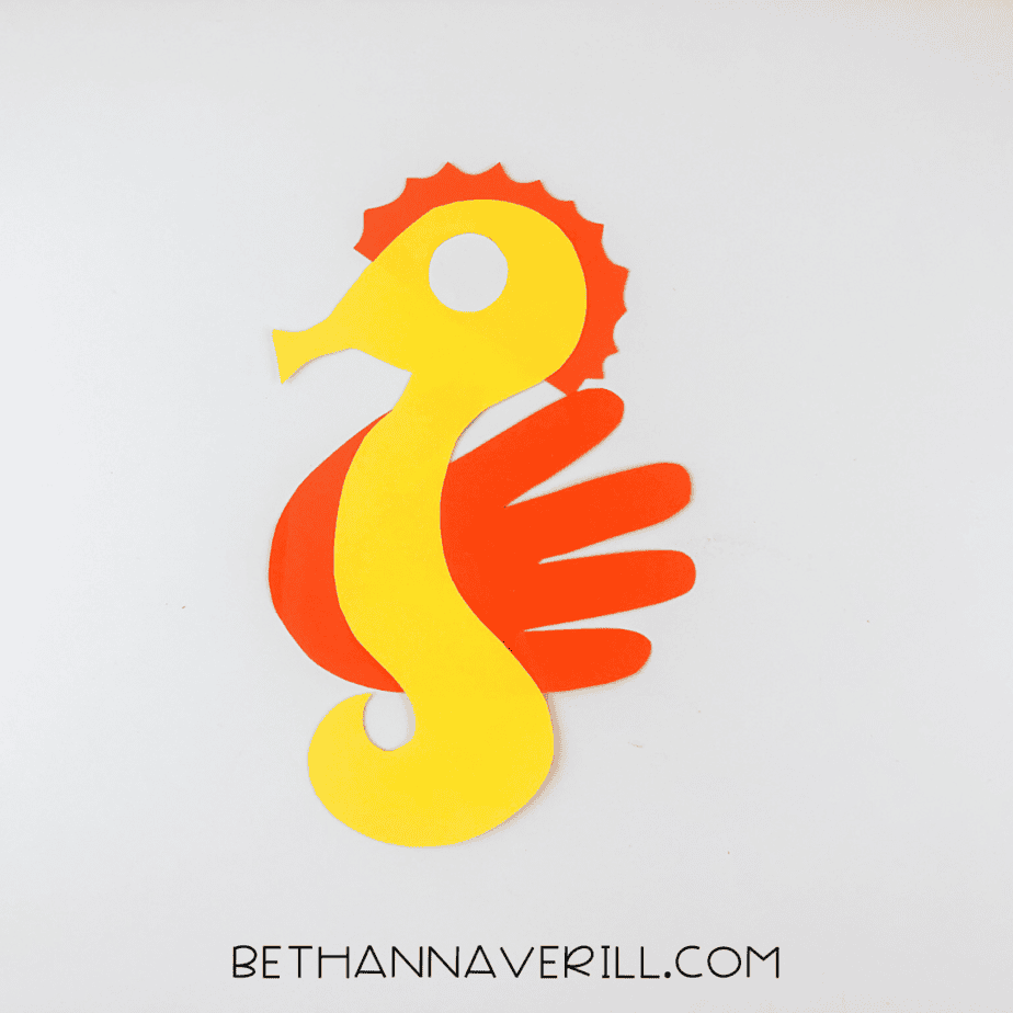Red handprint fin glued behind the seahorse body.