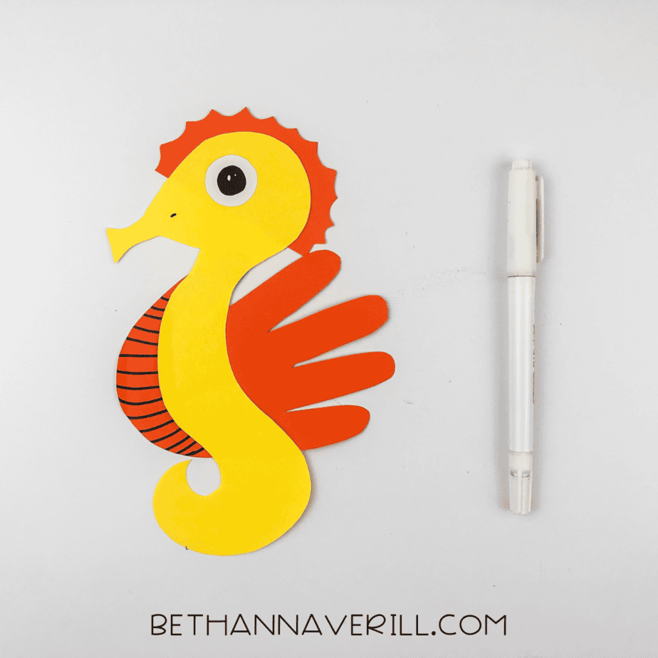 Black eye and belly stripes drawn on the seahorse.