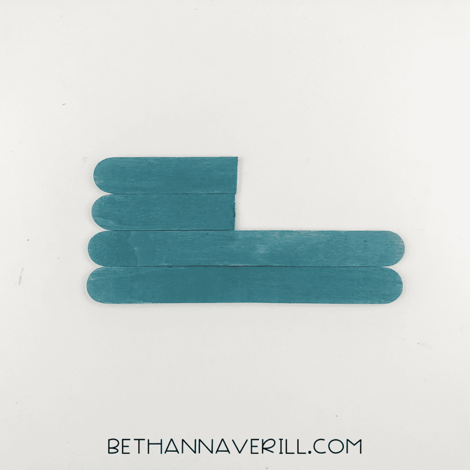 Popsicle sticks glued together in the shark body shape.