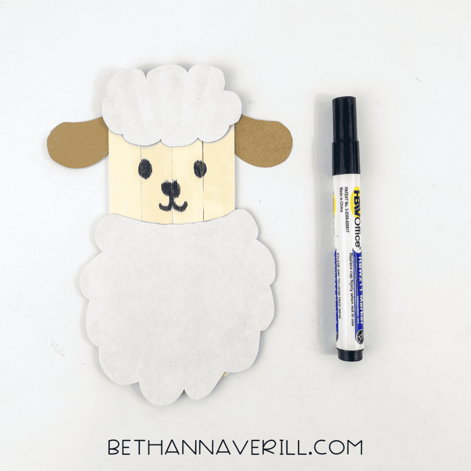 Face drawn on sheep using black marker