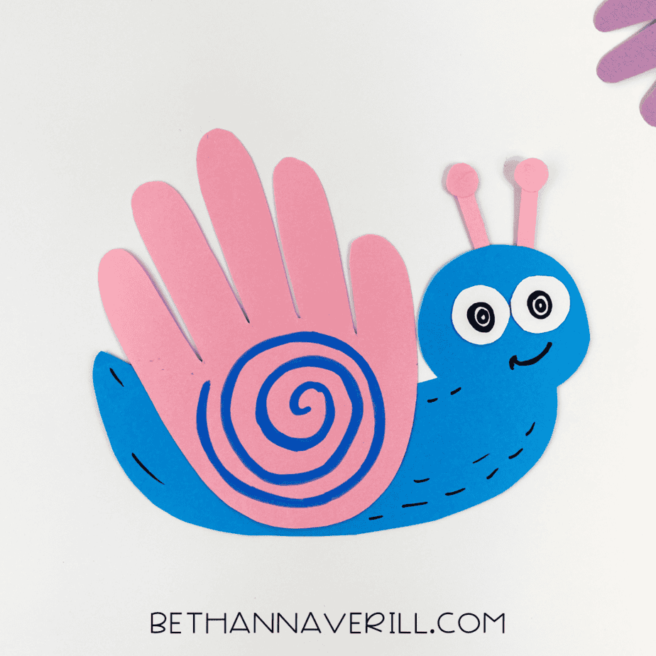 Final snail craft displayed with other decorations in the background