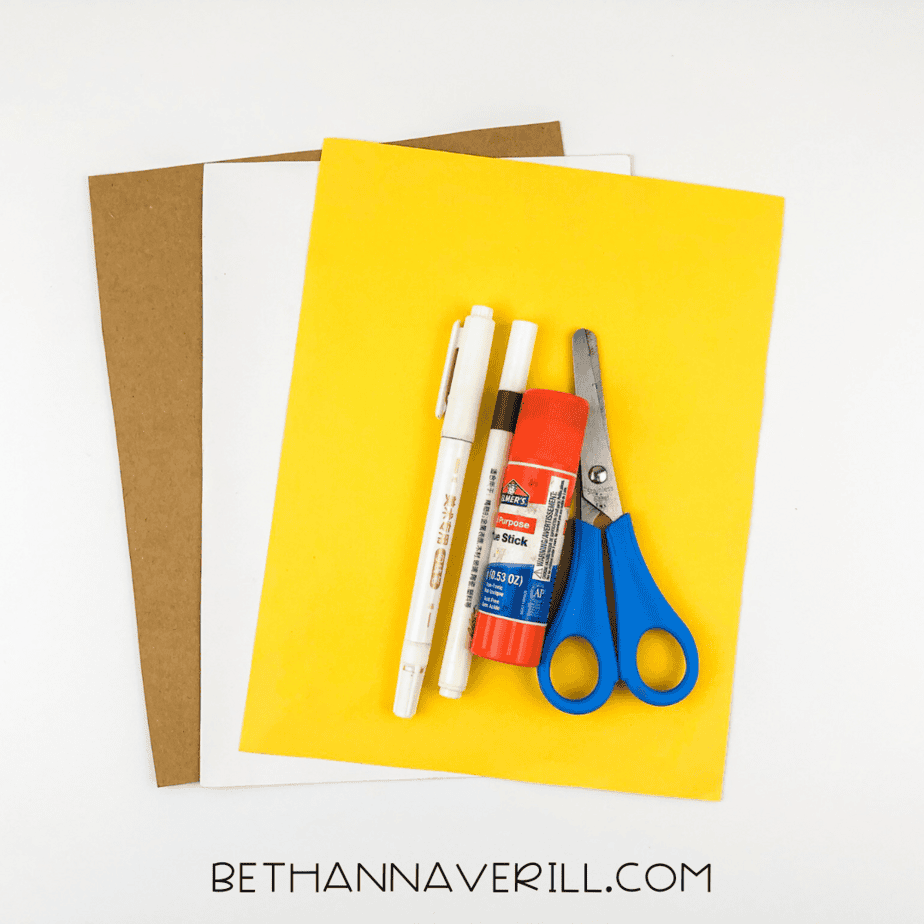 Sunflower handprint craft supplies including glue stick, scissors, markers, and construction paper