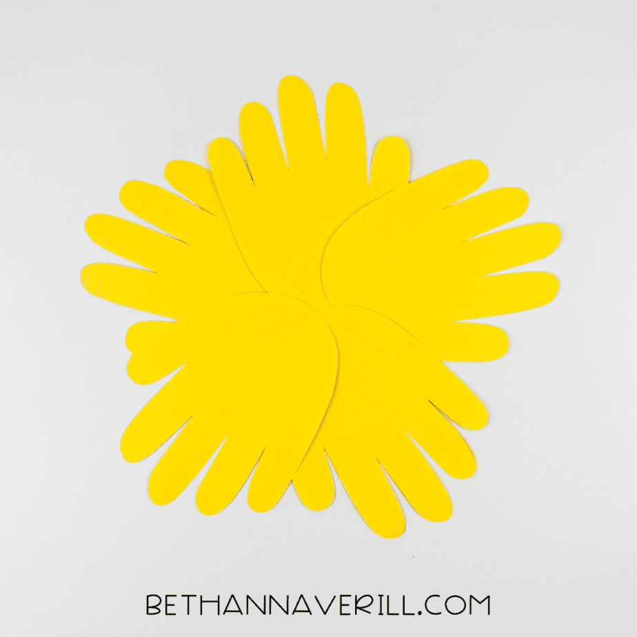 Yellow handprints arranged in a circular sunflower shape
