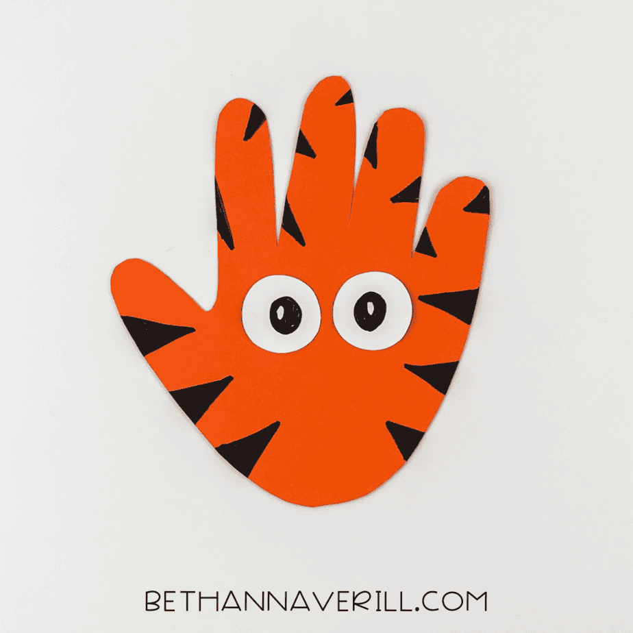 Orange handprint with white eyes glued in place