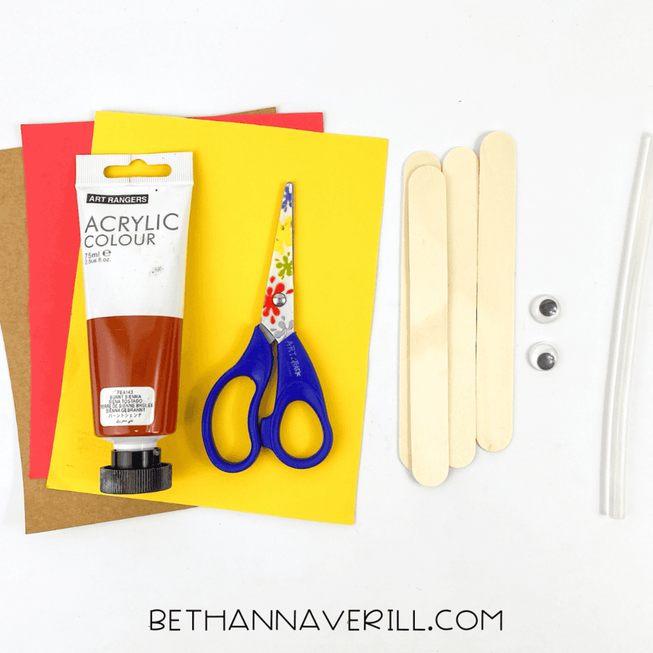 Turkey craft supplies: brown, yellow, red paper, brown paint, scissors, googly eyes, popsicle sticks, glue.
