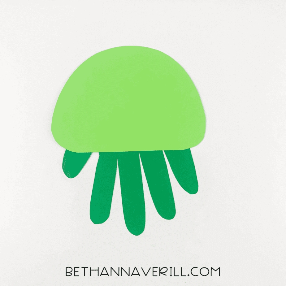 Handprint glued behind the green turtle shell.