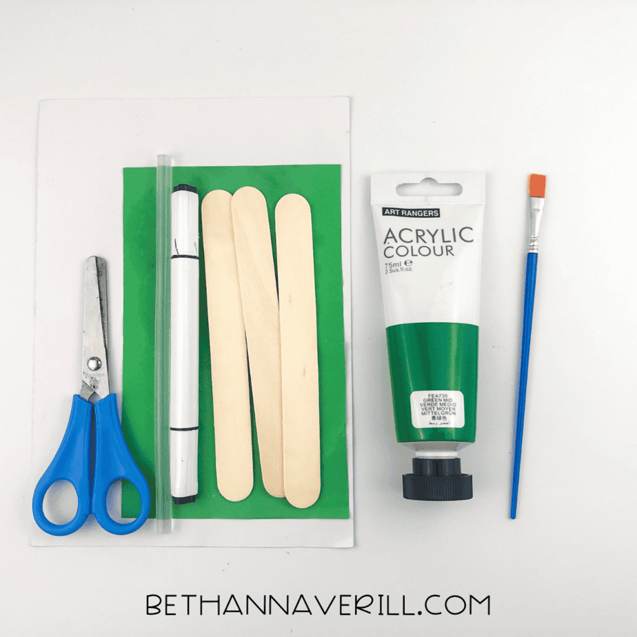 Turtle craft supplies: green paper, 3 craft sticks, green acrylic paint, brush, scissors, black marker, and glue.