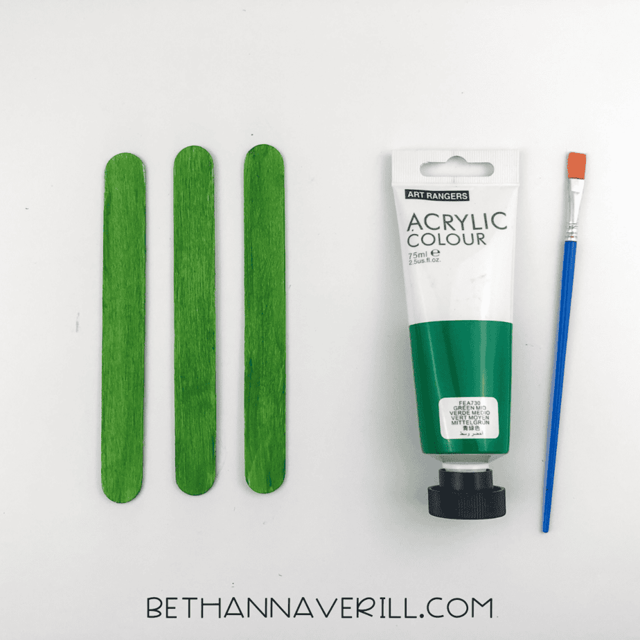 three popsicle sticks painted green