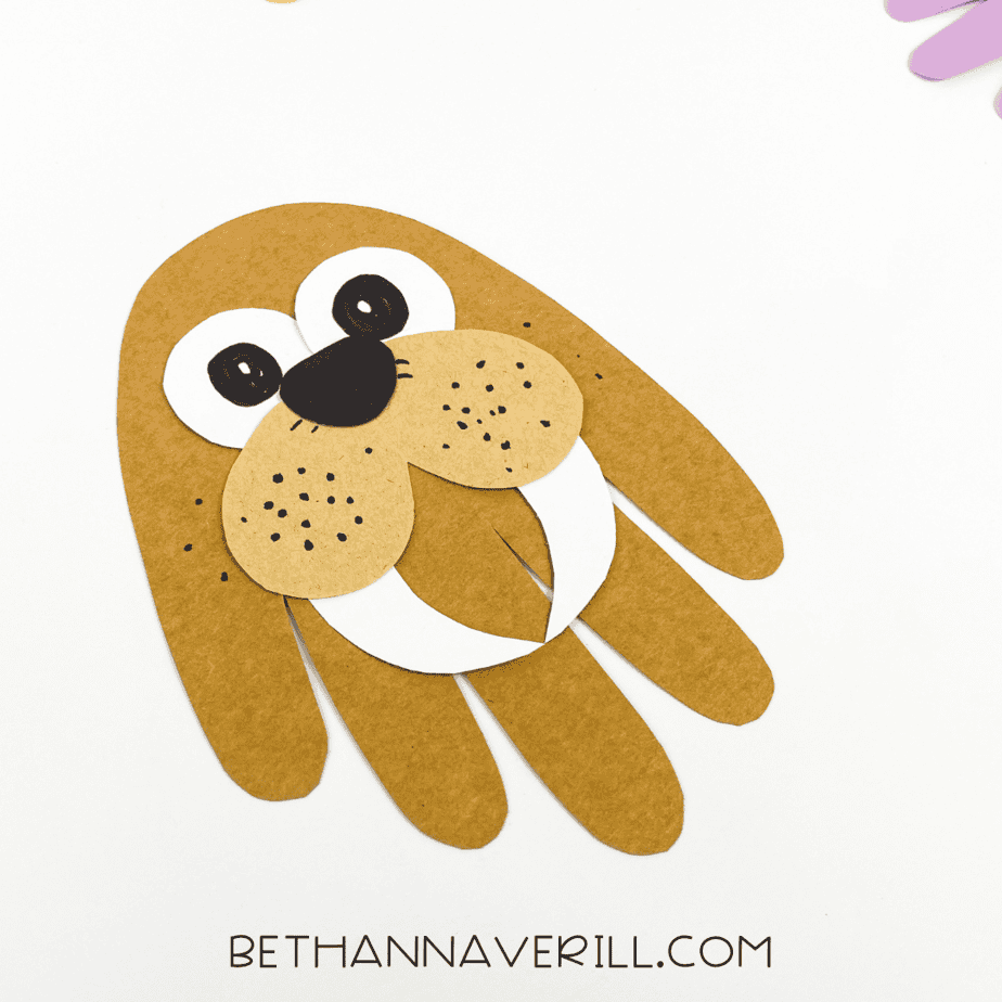 Angled close-up of completed walrus handprint craft.