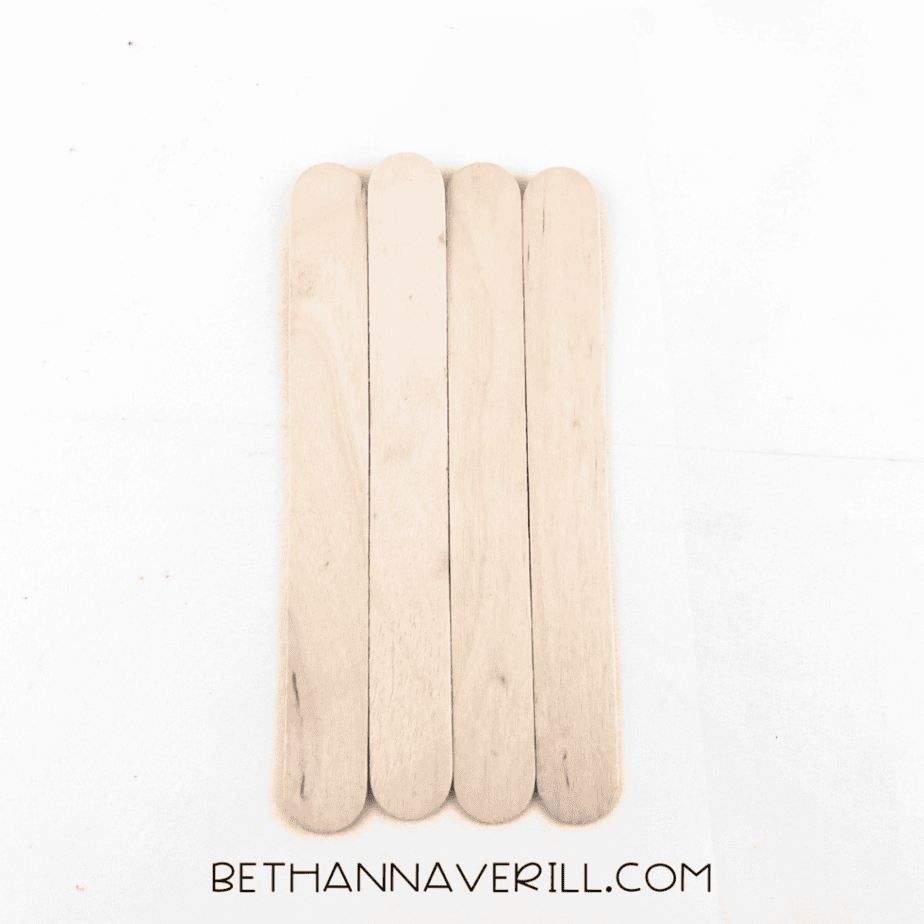 Back of four craft sticks taped together to form a base.