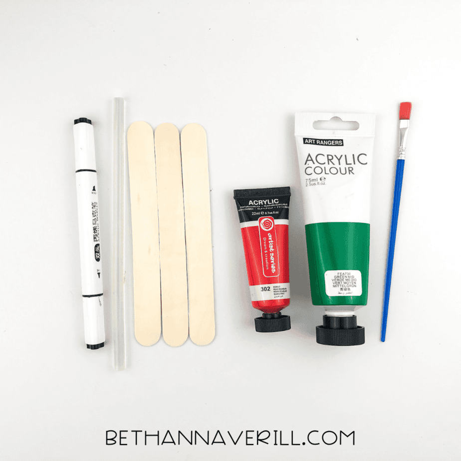 Craft supplies for watermelon craft: 3 popsicle sticks, red & green paint, brush, black marker, and glue.