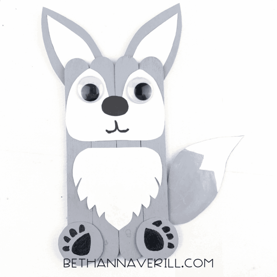 Finished popsicle stick wolf craft with ears, paws and tail