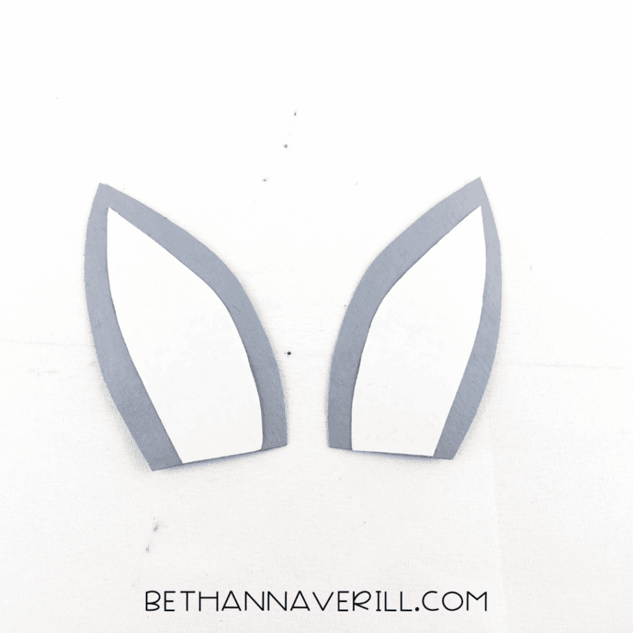 Two gray wolf ears with white centers
