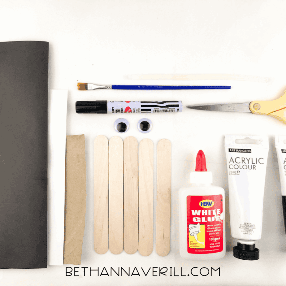 Wolf craft supplies: craft sticks, paint, glue, googly eyes, marker and paper