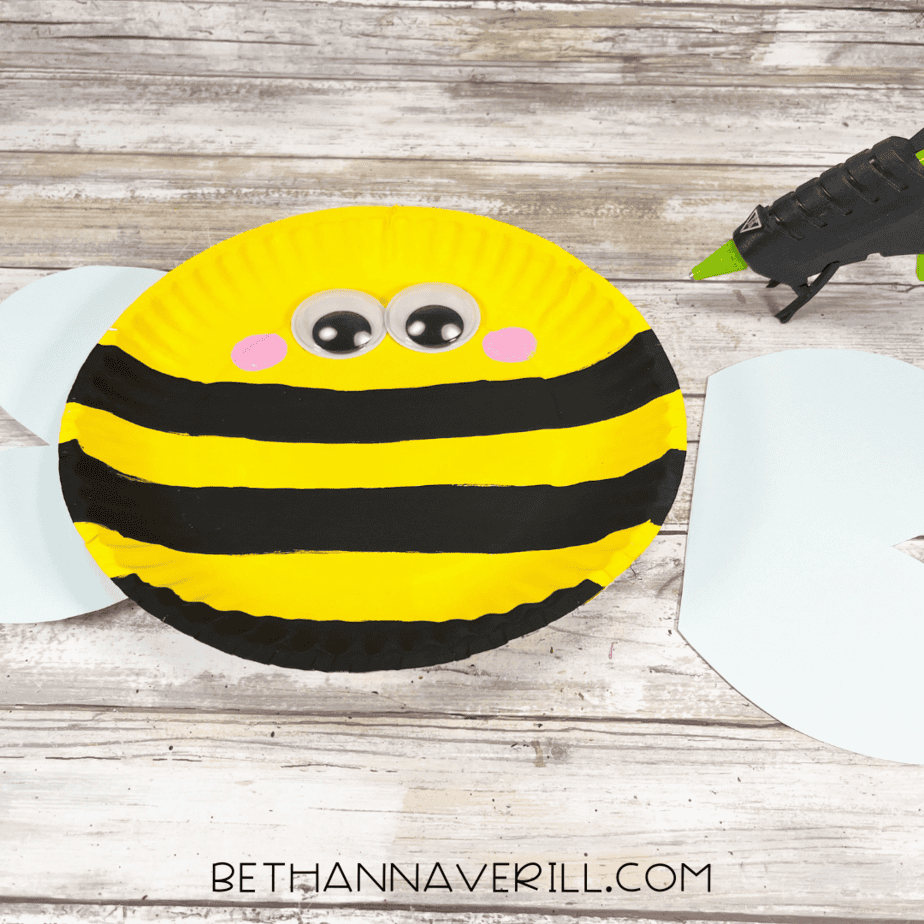 Bee body with googly eyes and cheeks, wings ready to be glued on.