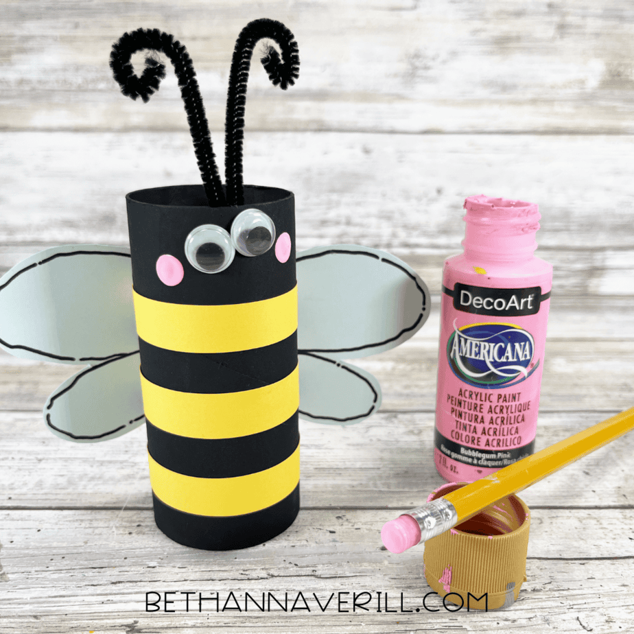 Bee craft with painted pink cheeks added using a pencil eraser.