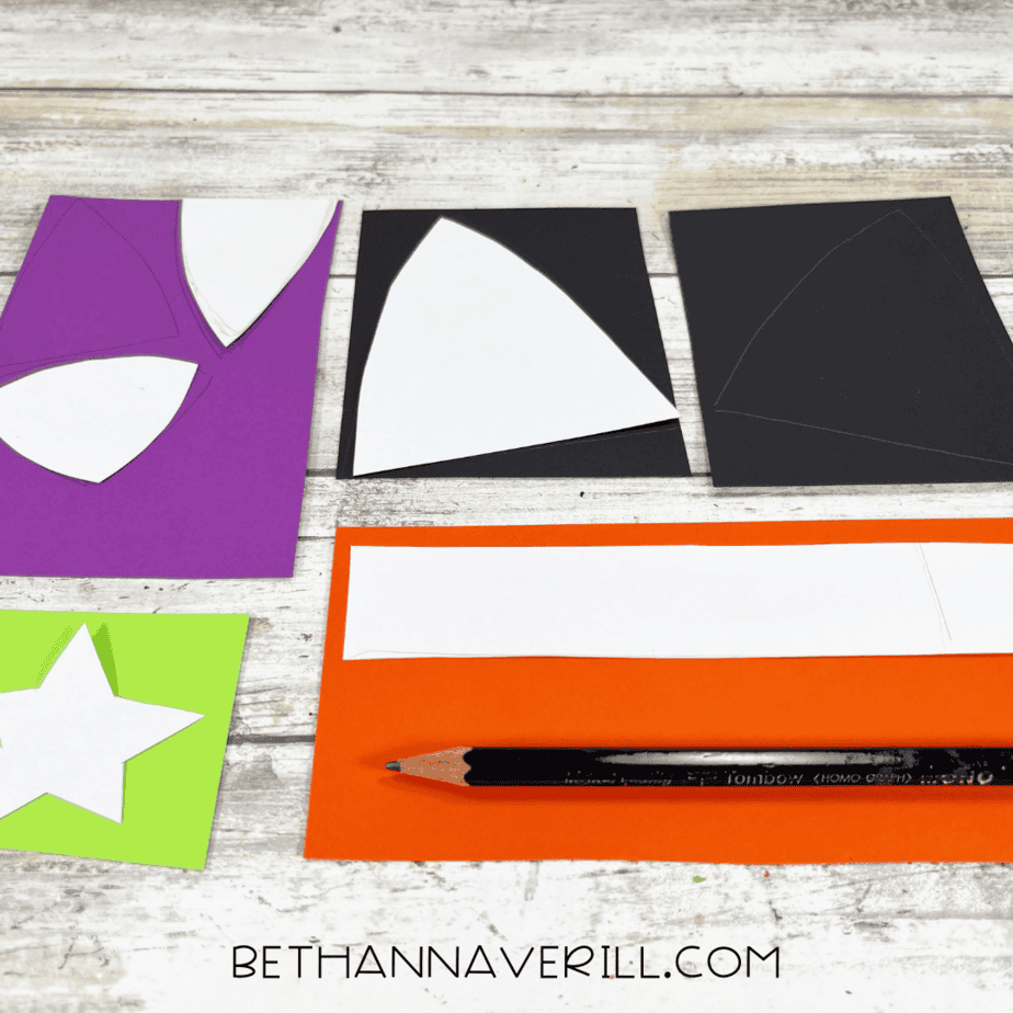 Paper templates traced on colored construction paper for ears, nose, collar, and star.