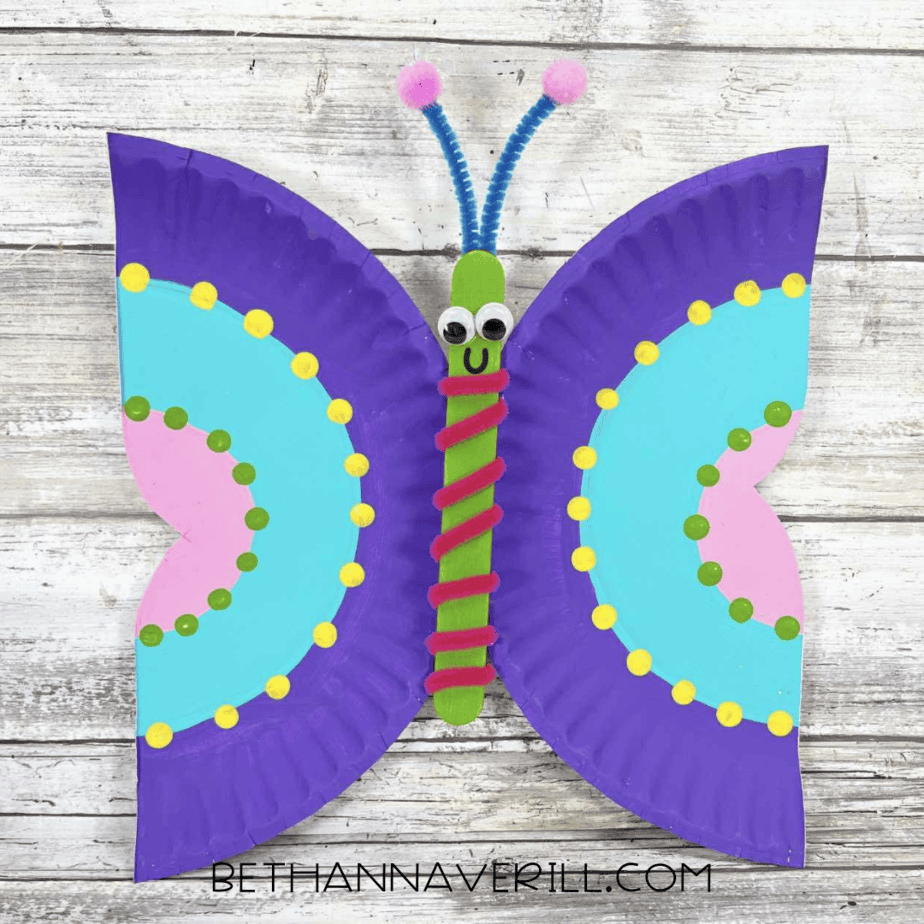 Finished butterfly craft with colorful wings and smiling face.
