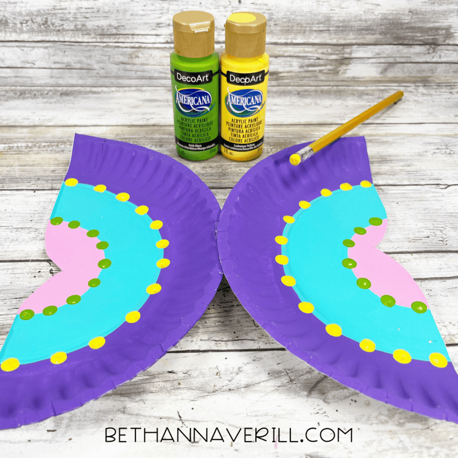 Butterfly wings decorated with yellow and green painted dots.