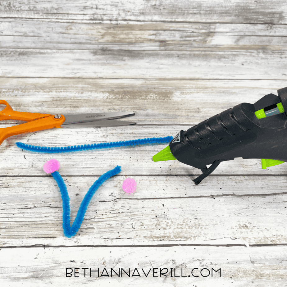Blue pipe cleaners with pink pom poms glued to ends for antennae.