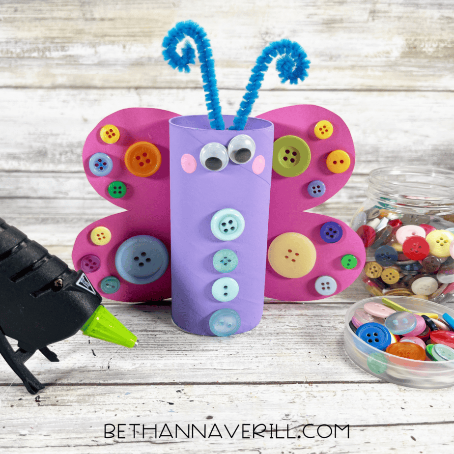 Butterfly craft with colorful buttons glued down the roll’s body.