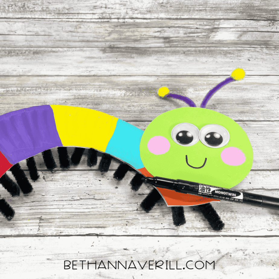 caterpillar with antennae attached, smiling face drawn with marker.
