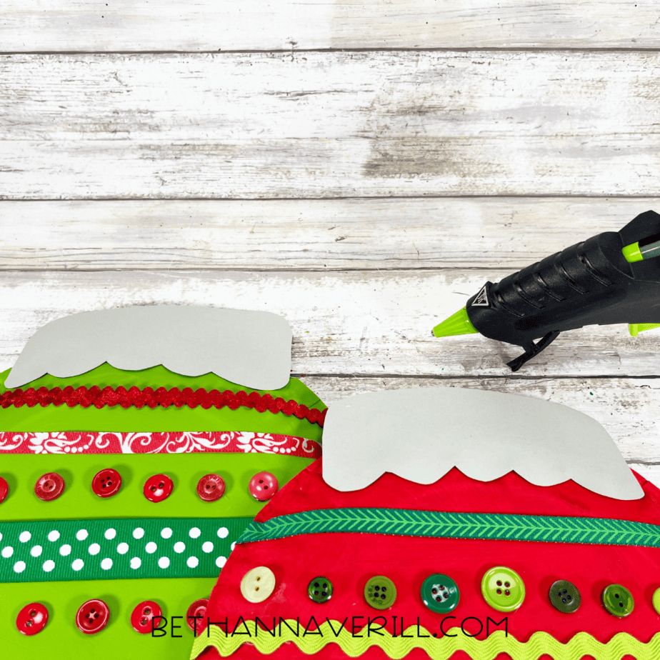 Ornament tops glued to the decorated paper plates.
