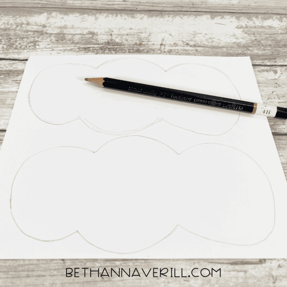 White paper with stocking top shapes drawn in pencil.