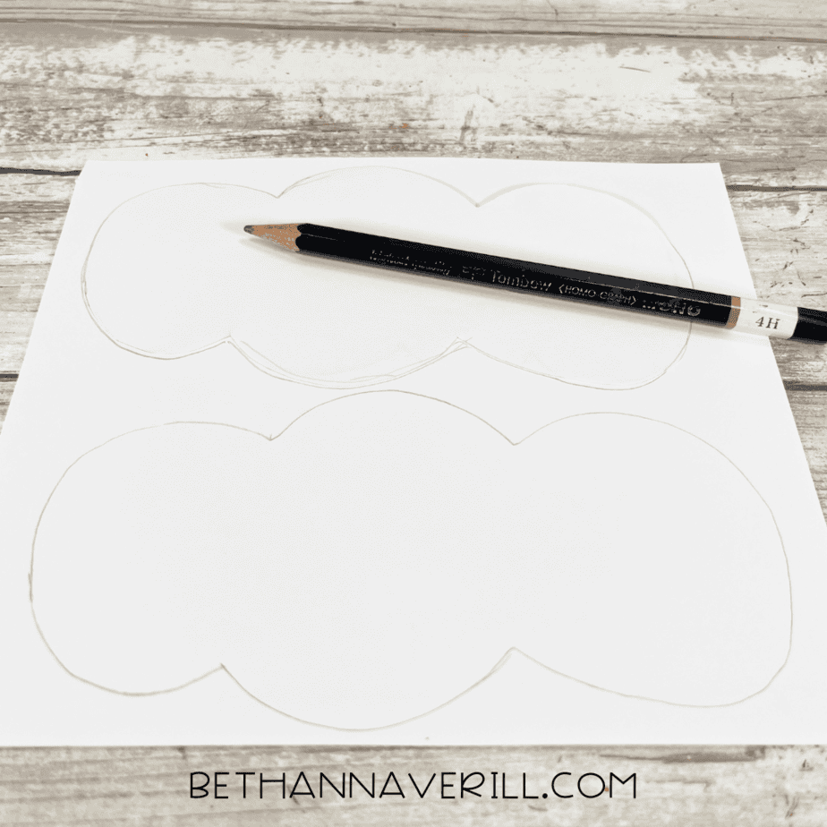 White paper with stocking top shapes drawn in pencil.