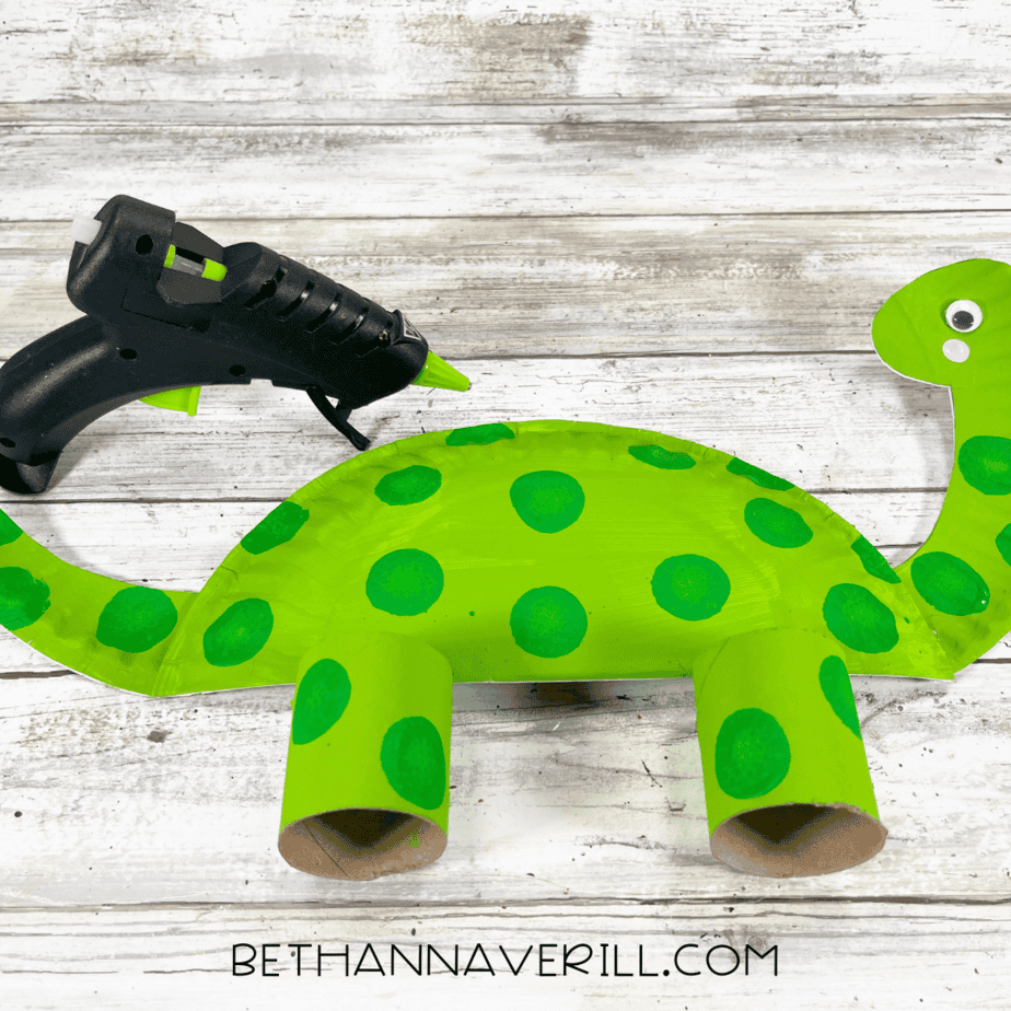 Dinosaur body with glued-on legs and spots.
