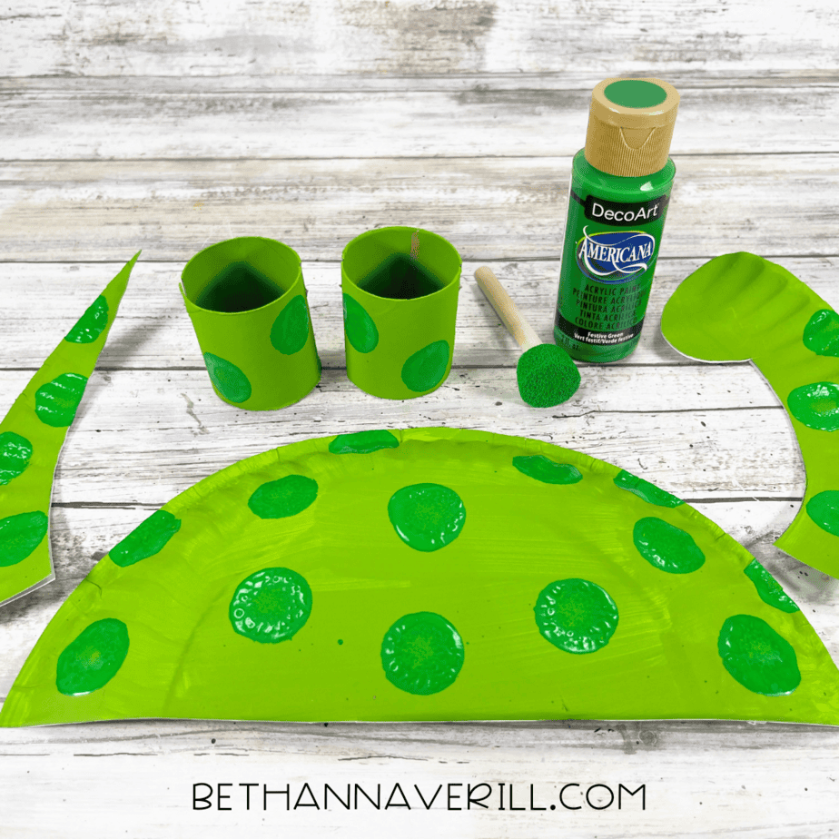 Green dinosaur pieces with darker green spots stamped on.