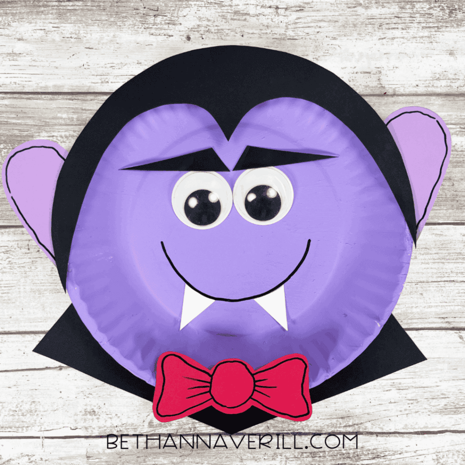 Finished Dracula paper plate craft with black hair, purple ears, and red bow tie