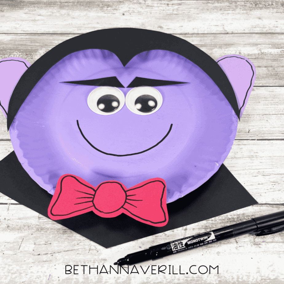 Black marker drawing a smile on the Dracula paper plate