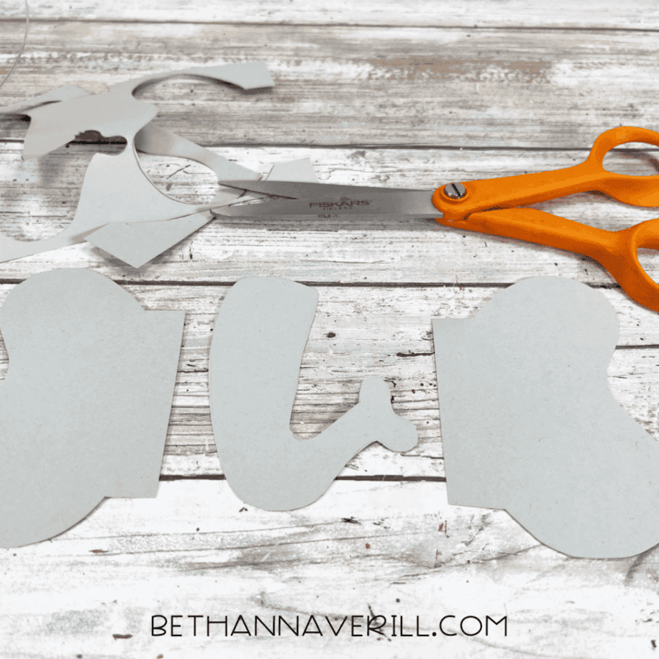 Cut-out elephant ears and trunk next to scissors.