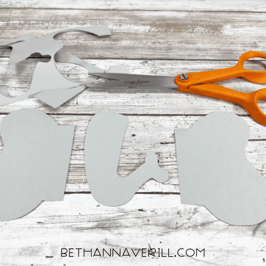 Cut-out elephant ears and trunk next to scissors.