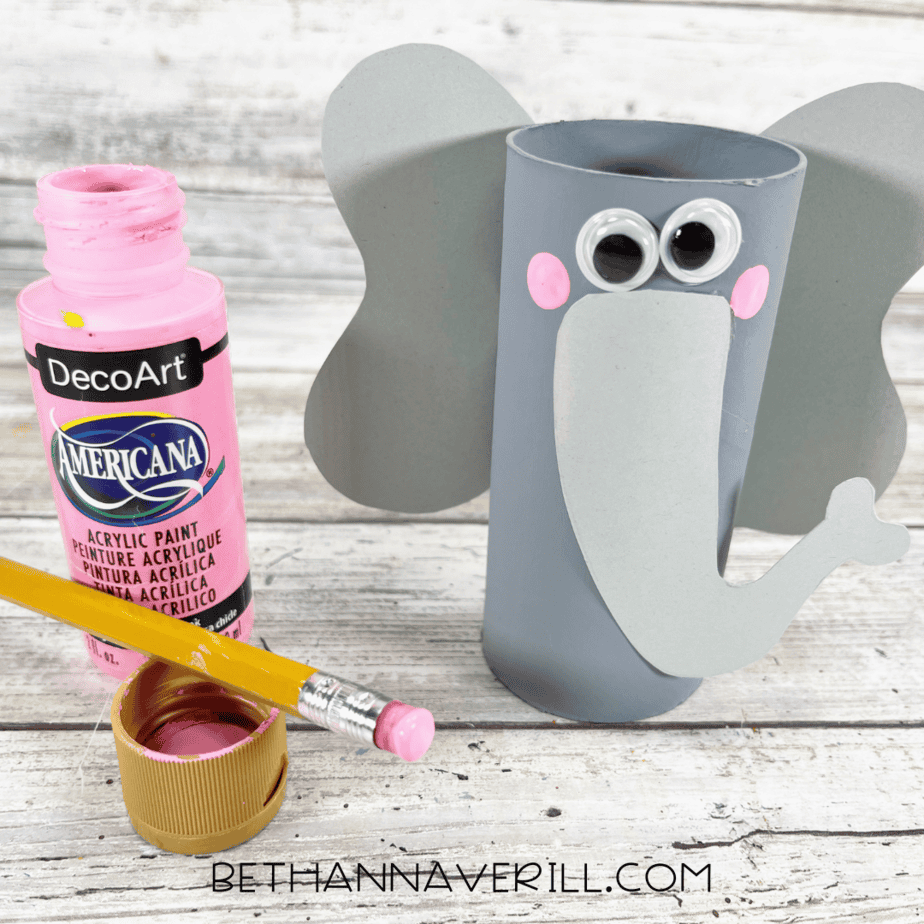 Elephant paper roll craft with ears, trunk, and pink painted cheeks.